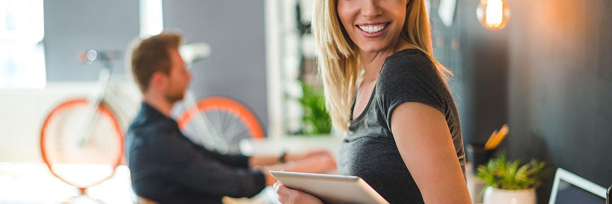 Beautiful businesswoman holding a digital tablet in a design studio.