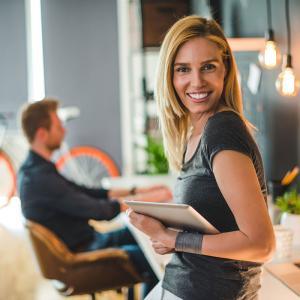 Beautiful businesswoman holding a digital tablet in a design studio.
