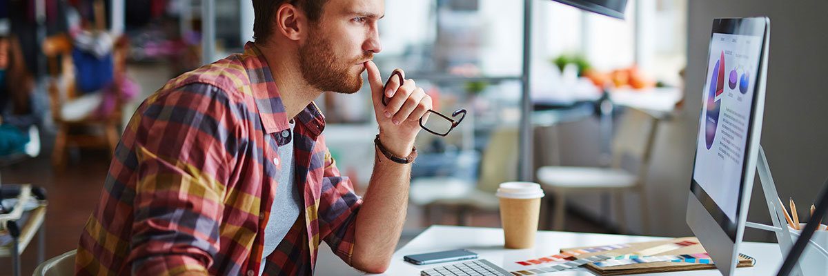 Modern designer sitting in front of computer in office